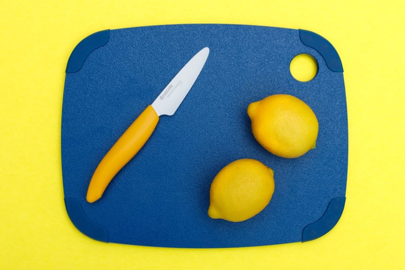 A plastic cutting board with lemons