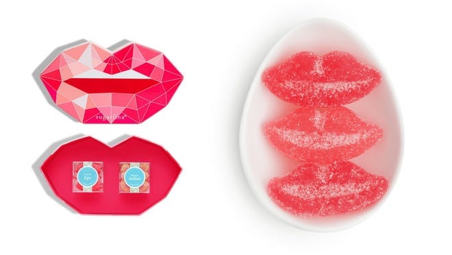 On left, lip-shaped package with two boxes of gummy candy inside. On left, three lip-shaped gummy candies in white egg-shaped bowl.