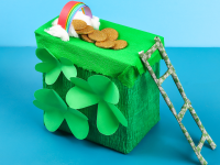 A DIY leprechaun trap with gold coins, a rainbow and a green ladder for St. Patrick's Day.