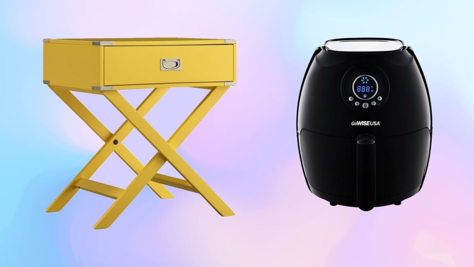 Yellow nightstand table and black air fryer in front of colorful background.
