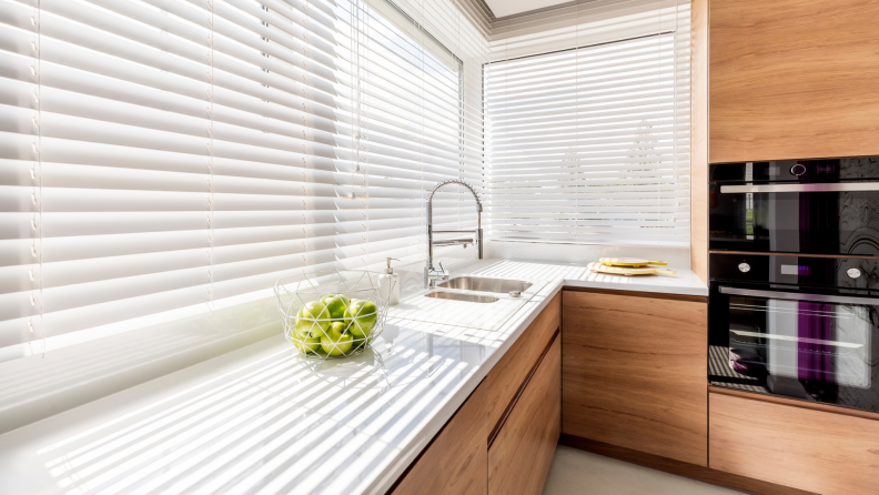 White blinds in modern style kitchen on a bright day.