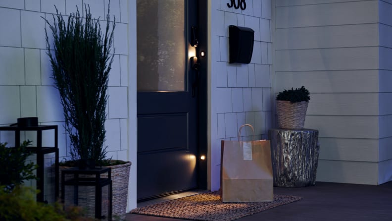 The Masonite M-Pwr Smart Door at night with the lights on.