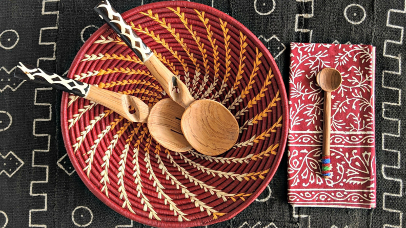 A bright red woven basket with decorative utensils