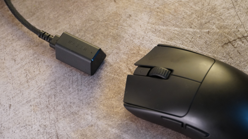 A black Razer Viper V3 Pro mouse, with a USB-C hyperpolling dongle
