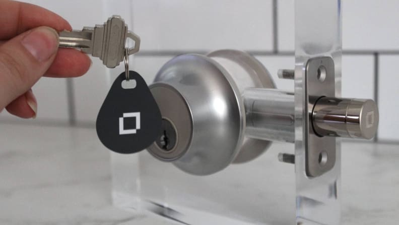 The Level Lock Plus Connect with a key fob hanging in front of the exterior lock face.