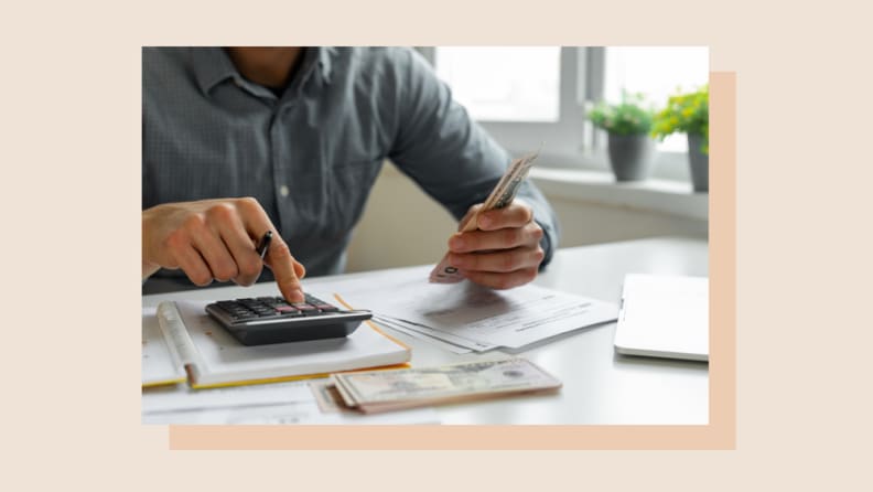 Person using calculator on desk.