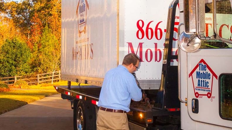 The owner inspecting his container truck