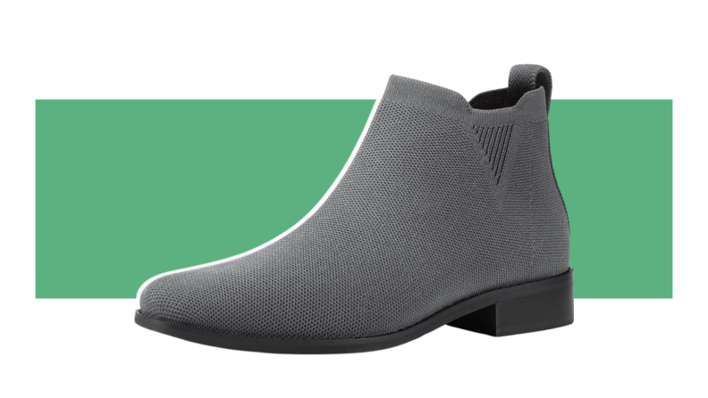 A single gray Bacia Sock Ankle Boot displayed in front of a green stripe.