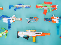 10 different Nerf guns on a light blue background