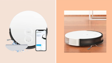white robot vacuum on floor and product photo next to phone