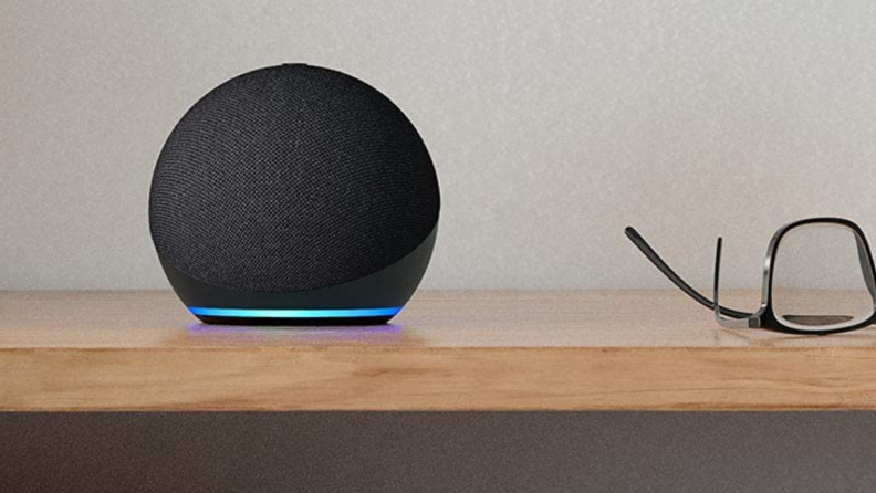 An Amazon Echo Dot sits on a table.