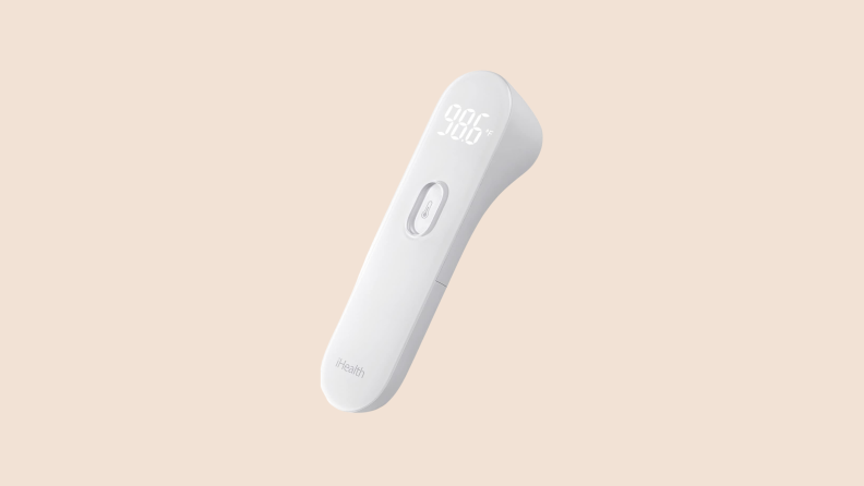 A sleek, white iHealth No Touch Forehead Thermometer on a tan background.