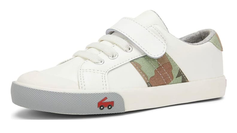A white sneaker with a camo stripe.