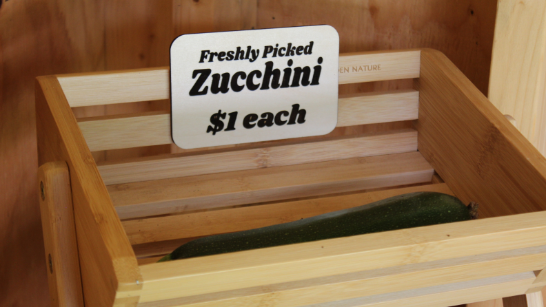 Sign that reads "freshly picked zucchini $1 each"