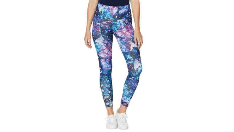 person wearing abstract leggings on white background