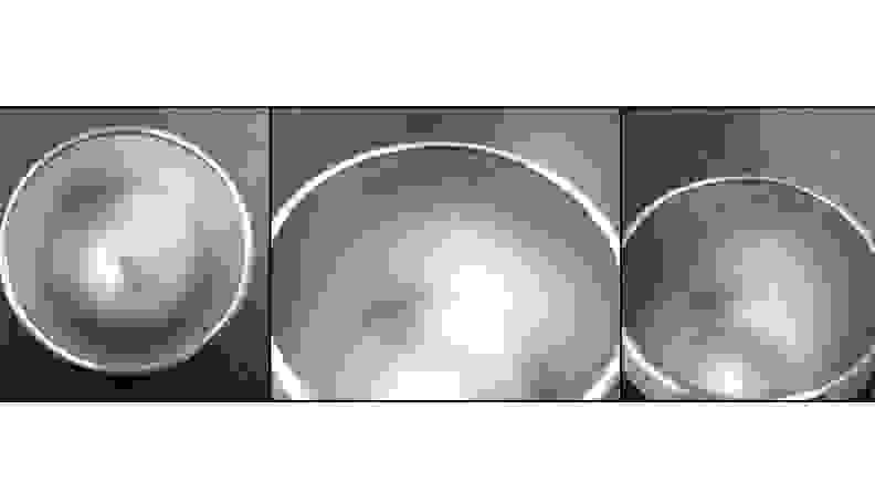 A series of three images against a blue Reviewed checkmark background. The first image shows the interior of the Yeti cup. It's pristine. The second image, after five washes, has some blackened wear towards the lip. The third image shows that blackening is actually forming a bit of a ring around the interior of the cup.