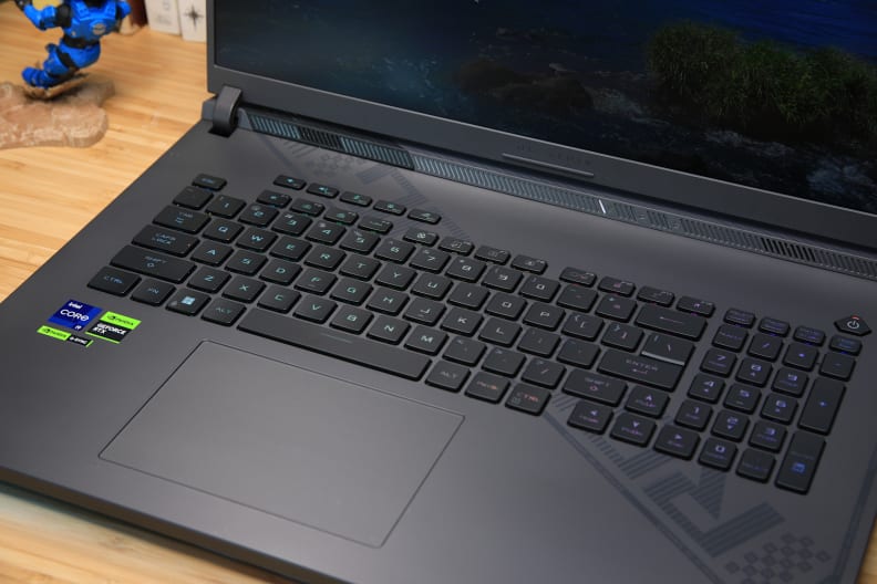 A black laptop on a light brown desk