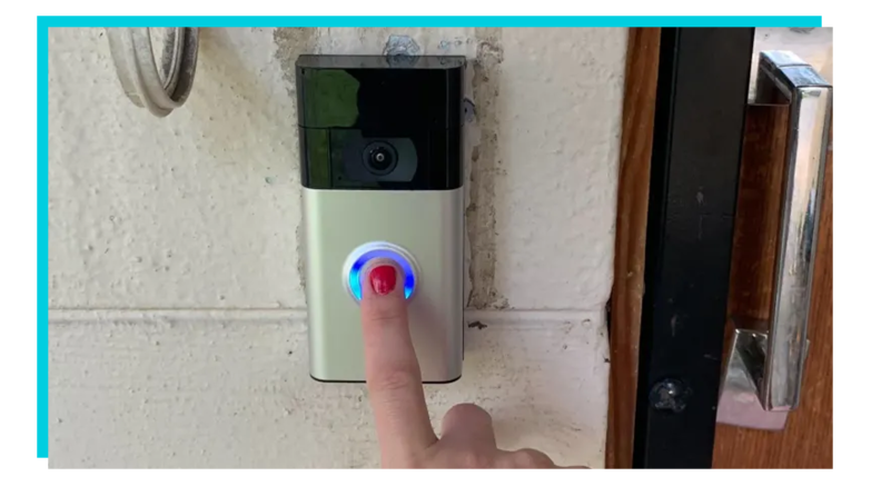 Person using Ring security camera to ring doorbell outside of home.