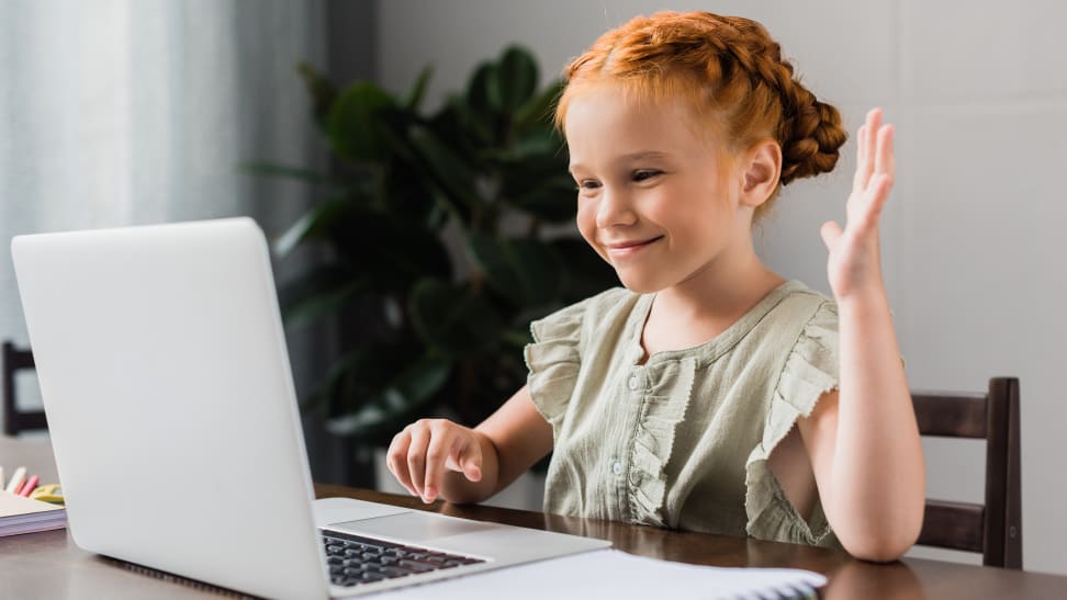 Girl waving to computer