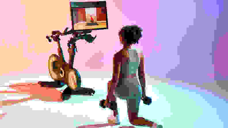 A woman exercising with the Echelon Fitness EX-8S