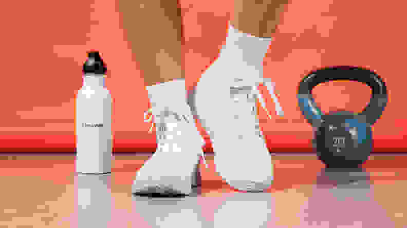 white sneakers next to 20 pound weight and water bottle
