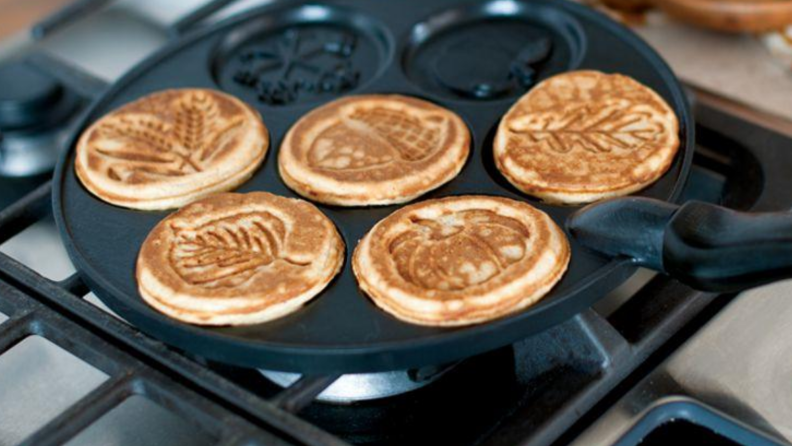 An image of a leaf-printed pancake griddle with autumn leaf impressions baked into the small pancakes.