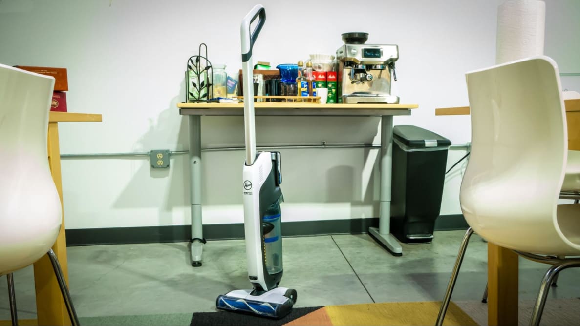 The Hoover Onepwr Evolve standing on hard floor and carpet.