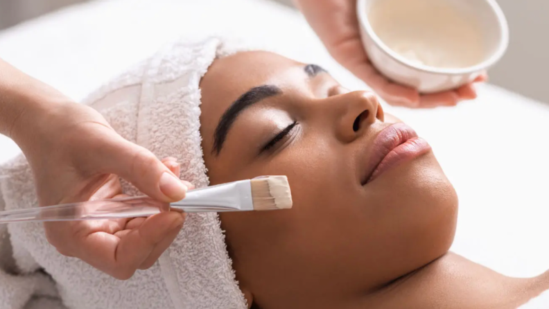A Black woman gets a soothing facial