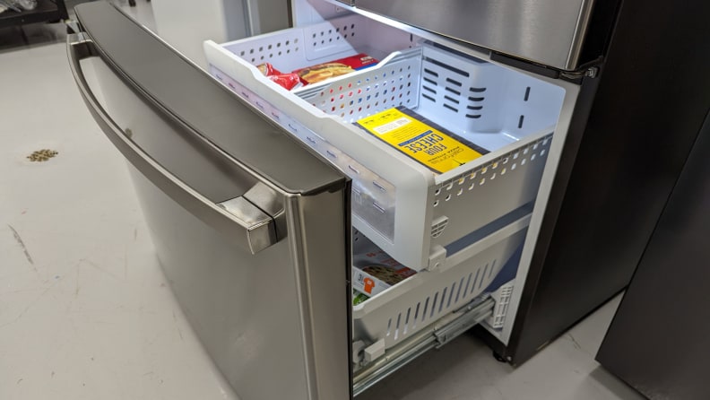 A close-up of the freezer drawer. Frozen foods are stocked in both the main bin and the drawer above.
