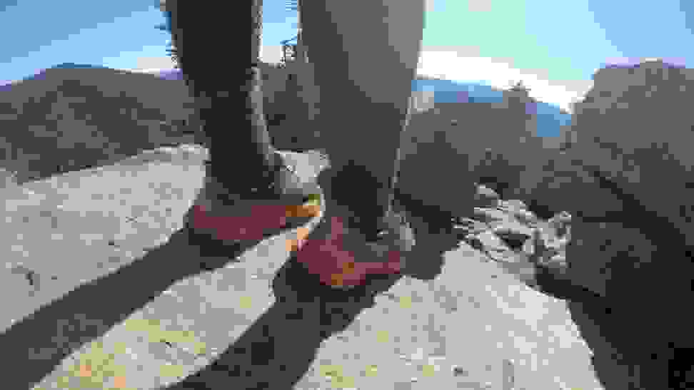 A hiker wearing a pair of Hoka running shoes