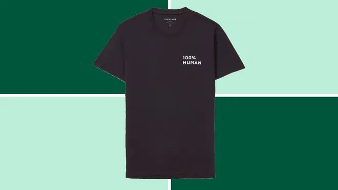 Everlane 100% Human Crew t-shirt on a dark and light green background.
