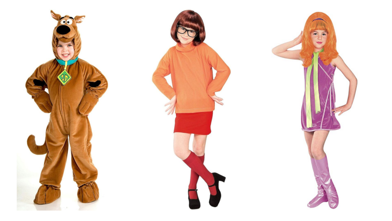 Three kids dressed up as characters from Scooby Doo: Scooby, Velma, and Daphne.