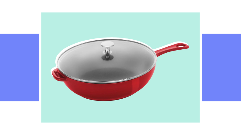 An image of a red Staub cast iron daily pan with a handle and a glass lid.