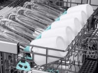 An open Samsung dishwasher with the 3rd rack pulled out to show cups and glasses, and the other 2 showing in the background.