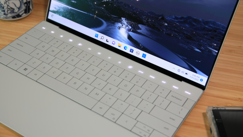 An open silver laptop showing its keyboard and trackpad.