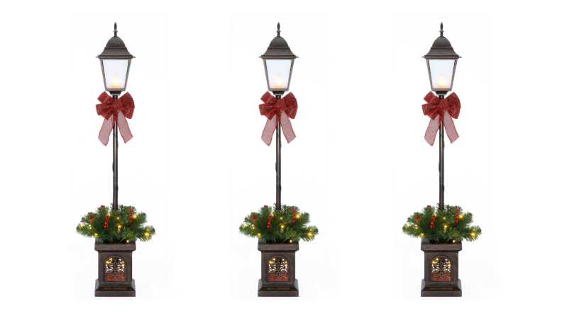 Three of the same holiday lantern decorations next to one another on a white background.