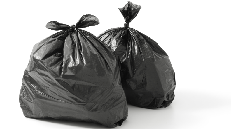 Two black trash bags on a white background.