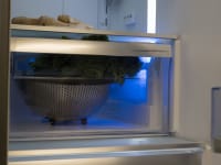 Produce on shelf in refrigerator.