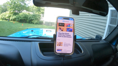 A smart phone on a RealTruck Rugged Ridge Dash Mult-Mount inside a car.