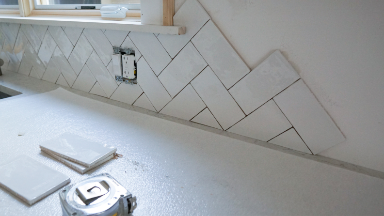 A tiled wall in a chevron pattern.