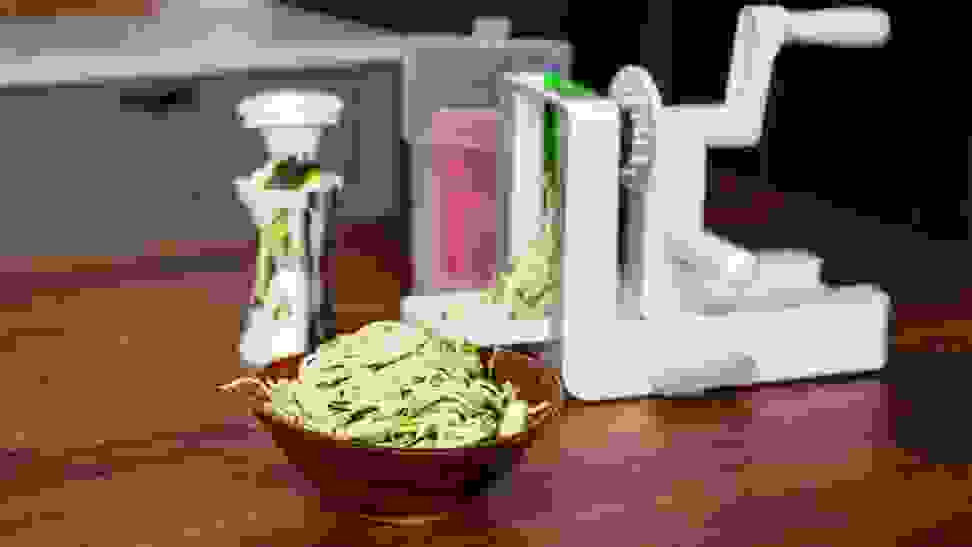 A bowl of zoodles created by the best spiralizers are displayed on a kitchen counter.