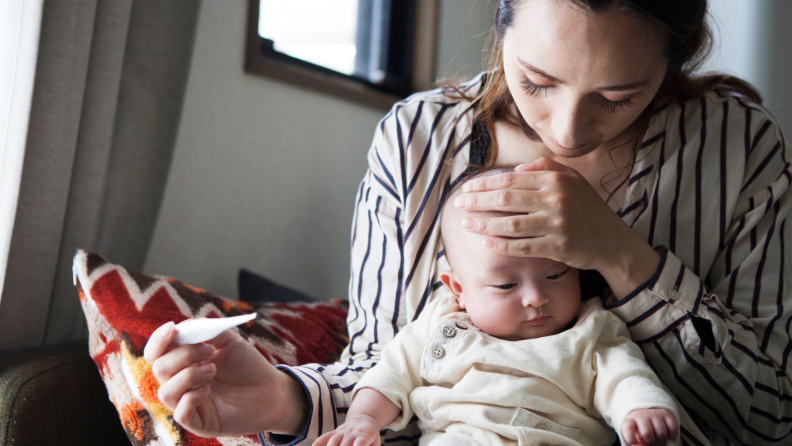 A baby whose fever is being measured.