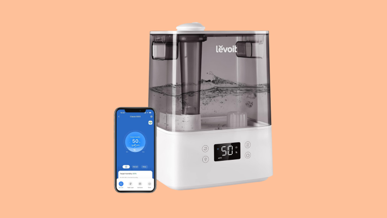 The LEVOIT Smart Humidifiers and Replacement Filter next to a smartphone.