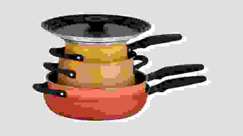 Orange, red, yellow stack of Meyer cookware with lid on top.