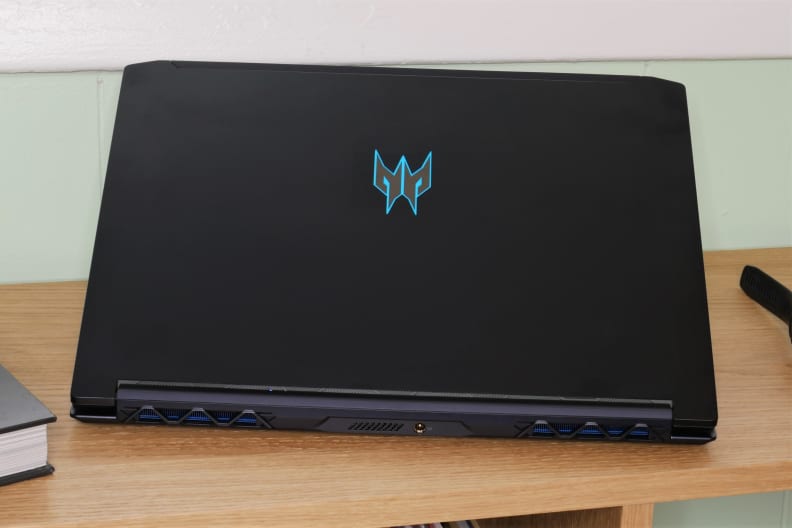 A photo of the Acer Predator Triton 300 gaming laptop open on a bench from the rear