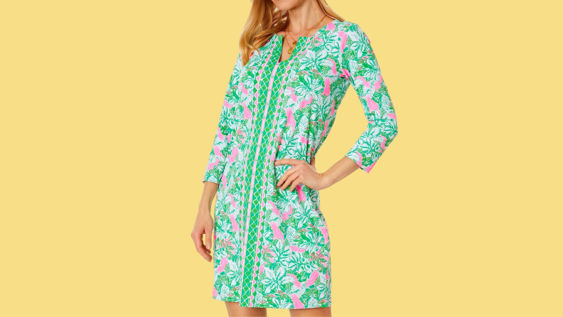A mini dress with a vibrant green and pink print.
