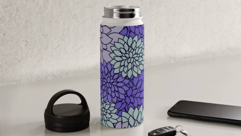 A purple water bottle on a kitchen counter.