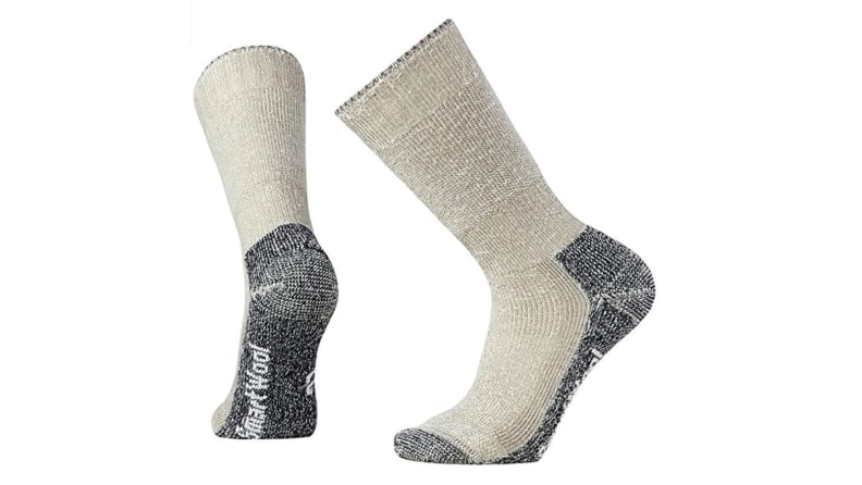 A pair of wool socks are shown as if being worn, or in motion, against a white backdrop.