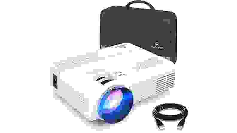 The Vankyo Leisure 3 mini projector, a small white box with built-in controls and a large lens on one side, sits beside a leather carrying case.