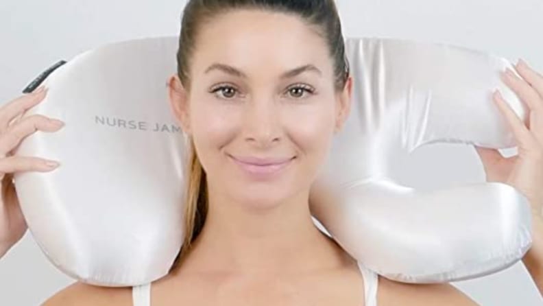 a woman holds the beauty bear pillow
